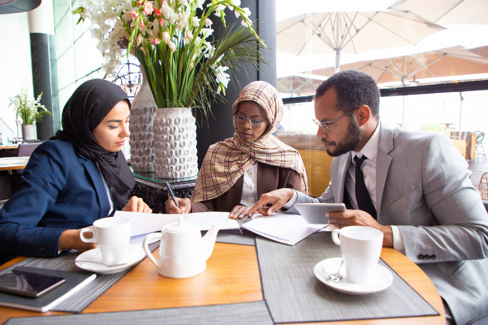 multicultural-business-partners-discussing-contract-cafe (2)
